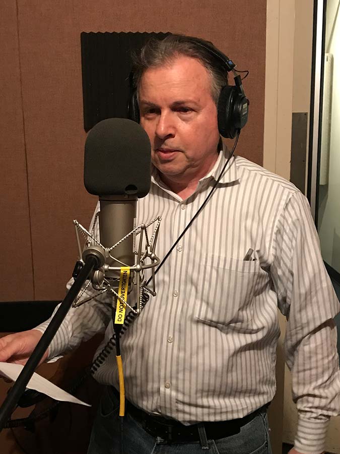 Photo of Marty Edelstein recording in a studio.